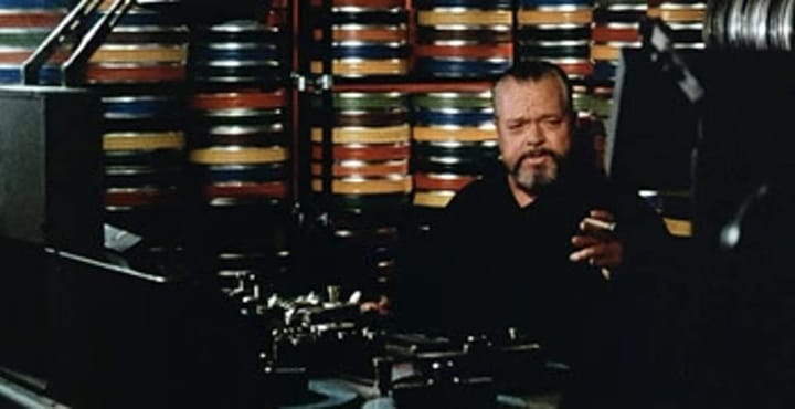 A photo of Orson Welles enjoying another cigar in his edit suite.