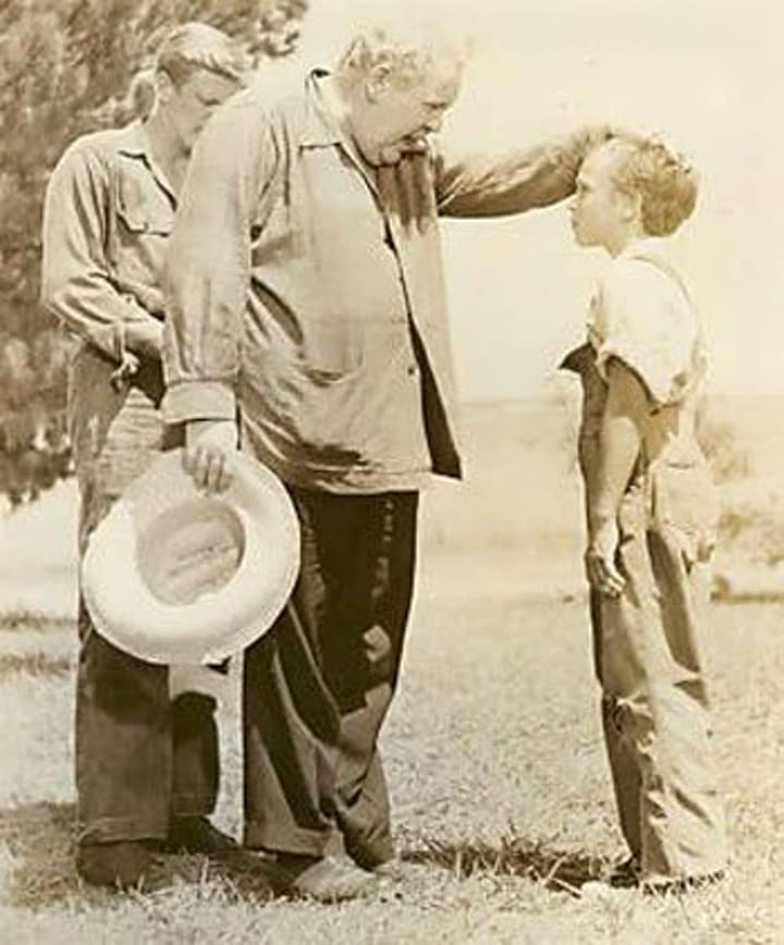 Photo of Director Charles Laughton on location with actors Peter Graves and Billy Chapin.