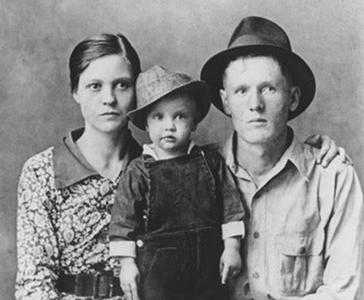 Photo of a young Elvis Presley with mother Gladys and father Vernon.