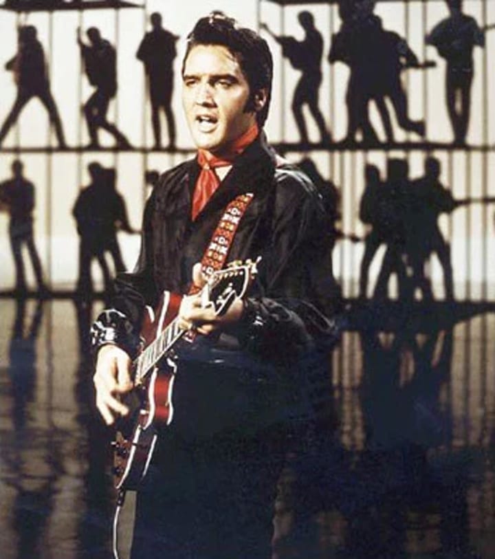 Photo of Elvis Presley a guitar from the “The Wrecking Crew” to you in his 1968 Television Special.